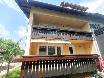 a house with a fence in front of it at Apartment LakeBled with Casle Bled view in Bled