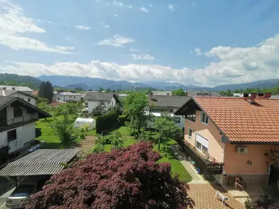 an aerial view of a town with houses and trees at Apartment LakeBled with Casle Bled view in Bled