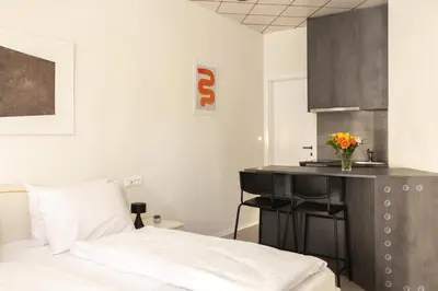 a bedroom with a bed and a table with a vase of flowers at Apartments Trzin-Mlake w FREE Parking in Trzin