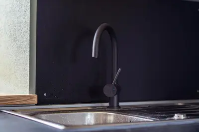 a kitchen sink with a faucet on top of it at Holiday Home Lož in Stari Trg pri Ložu