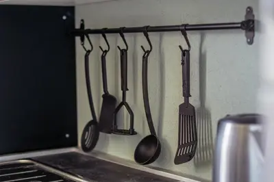 a group of kitchen utensils hanging on a wall at Holiday Home Lož in Stari Trg pri Ložu