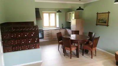 a kitchen with a table and chairs in a kitchen at Holiday Home Lož in Stari Trg pri Ložu