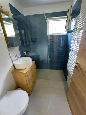 a bathroom with a toilet and a sink and a shower at River Apartment in Bovec