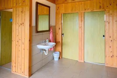 a bathroom with a sink and a mirror at GLAMPING HOUSE RANČ LUŽE in Luže