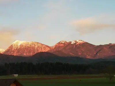 a mountain range with snow capped mountains in the distance at GLAMPING HOUSE RANČ LUŽE in Luže