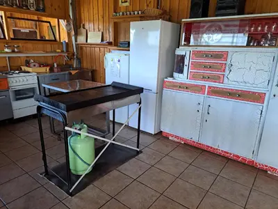 a kitchen with a refrigerator and a table in it at GLAMPING HOUSE RANČ LUŽE in Luže
