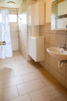 a bathroom with a sink and a toilet at GLAMPING HOUSE RANČ LUŽE in Luže