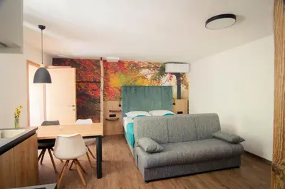 a bedroom with a bed and a table and a chair at Apartments with Private Saunas - WELLNESS Gobi in Podčetrtek