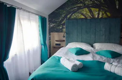 a bedroom with a bed with green and white pillows at Apartments with Private Saunas - WELLNESS Gobi in Podčetrtek