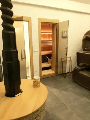 a living room with a table and a room with a door at Haloze na dlani - Haloze in your hand, hiša s pogledom na hribe - a house vith a view of hills in Gruškovec