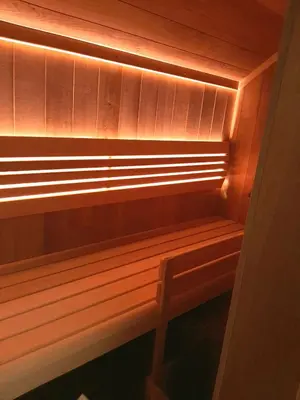 a wooden bench with a light on it at Haloze na dlani - Haloze in your hand, hiša s pogledom na hribe - a house vith a view of hills in Gruškovec