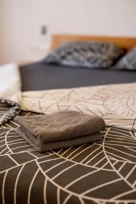 a brown and white bed with a brown and white comforter at Luxury apartments Prežin in Pohorje