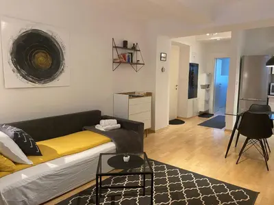 a living room with a couch and a table at Boennium Apartments Green Oasis in Ljubljana