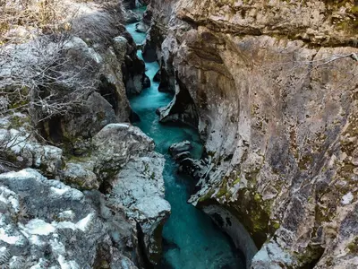 an aerial view of a river in a rocky canyon at Roja House in Soča