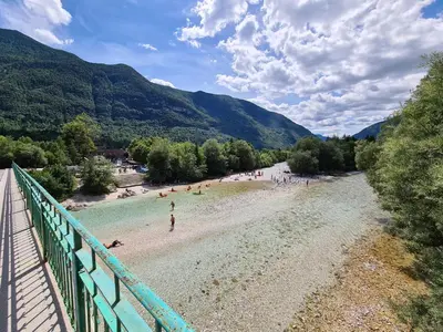a view of a beach with people in the water at Apartma Dora Bovec in Bovec