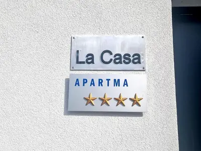 a sign for la casaarmaarma on a wall at Apartma La Casa in Radovljica