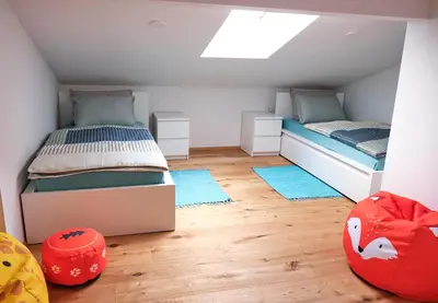 a attic bedroom with two beds and a skylight at Apartma La Casa in Radovljica