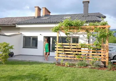 a woman standing in the doorway of a house at Apartma La Casa in Radovljica
