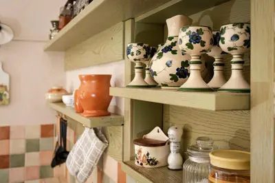 a shelf with vases and other ceramics on it at Apartment Island Country House in Savinja Valley in Žalec