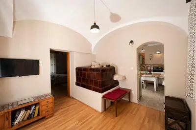 a living room with a tv on a wall at Apartment Island Country House in Savinja Valley in Žalec