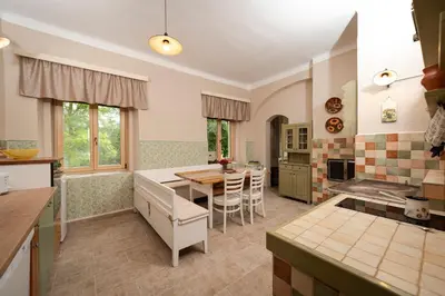 a kitchen with a table and a dining room at Apartment Island Country House in Savinja Valley in Žalec