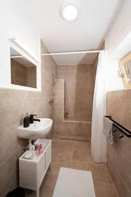 a bathroom with a sink and a shower at Apartment Island Country House in Savinja Valley in Žalec