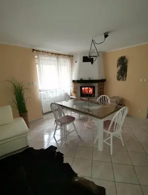 a living room with a table and chairs and a fireplace at Apartma Qbed in Gračišče