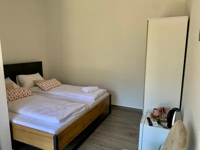a small bedroom with two beds in it at Panorama rooms in Bovec