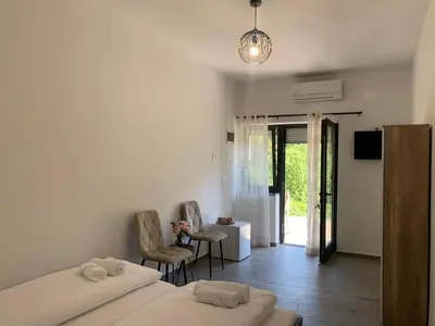 a bedroom with two beds and a living room at Panorama rooms in Bovec