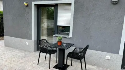 a black table and chairs in front of a building at Panorama rooms in Bovec