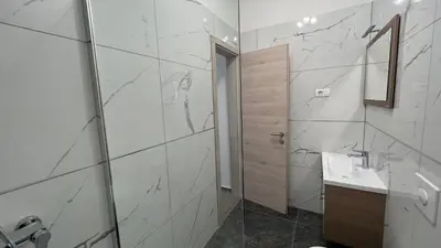 a white bathroom with a sink and a shower at Panorama rooms in Bovec