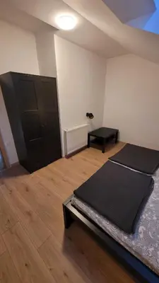 a room with a bed and a black door at Apartma Krupa in Gradac