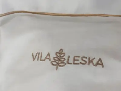 a close up of a white shirt with the word vla esbia at Apartments Vila Leska in Zgornji Leskovec