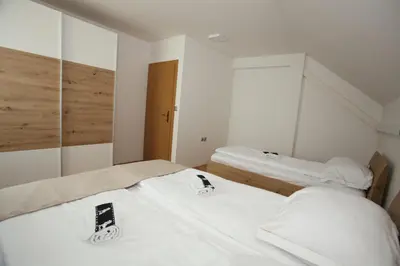 two beds in a room with two cell phones on them at Apartments Vila Leska in Zgornji Leskovec