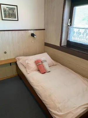 a bed in a room with two pillows on it at Apartma Anton in Kranjska Gora