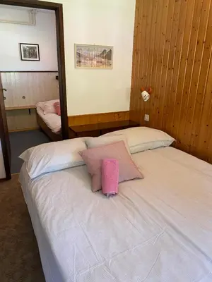 a bedroom with two beds with a pink pillow at Apartma Anton in Kranjska Gora
