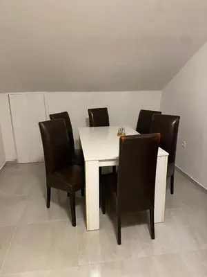 a white table with black chairs and a white table at Perfect stay 2 in Maribor