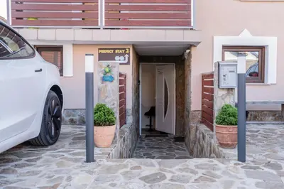 a white car parked in front of a building at Perfect stay 2 in Maribor