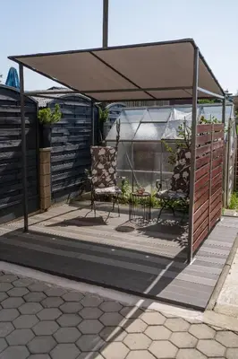 a gazebo with a table and a chair under it at Perfect stay 2 in Maribor