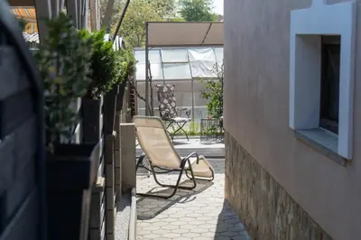 a chair sitting on a patio next to a building at Perfect stay 2 in Maribor