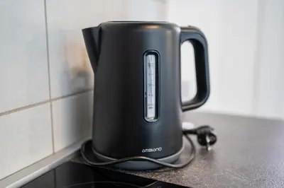 a black kettle sitting on top of a counter at Perfect stay 2 in Maribor