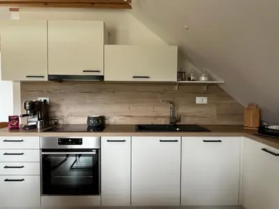 a kitchen with white cabinets and a stove at Apartma Ana in Manca in Begunje na Gorenjskem