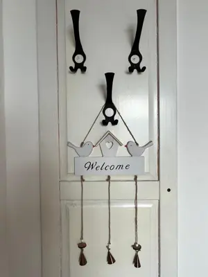 a door with a welcome sign and some utensils at Apartma Ana in Manca in Begunje na Gorenjskem