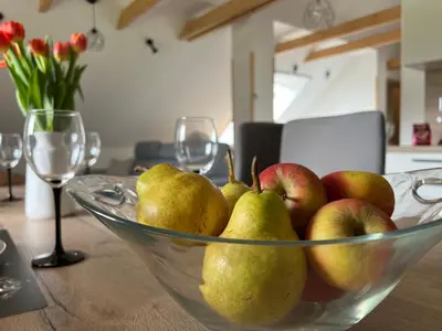 a glass bowl of pears and apples on a table at Apartma Ana in Manca in Begunje na Gorenjskem
