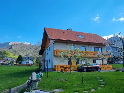 a house with a car parked in front of it at Apartma Ana in Manca in Begunje na Gorenjskem