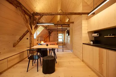 a kitchen and dining room with a table and chairs at NATUR BAJTA in Solčava