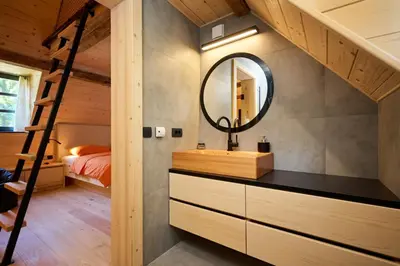 a bathroom with a sink and a mirror in a room at NATUR BAJTA in Solčava