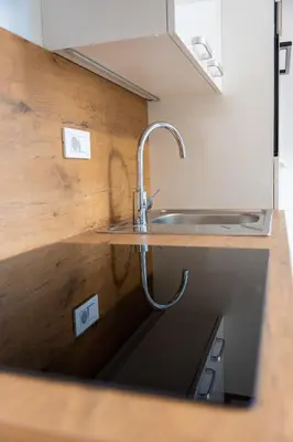 a kitchen with a sink and a counter top at Na-Ture Apartments in Zgornje Gorje