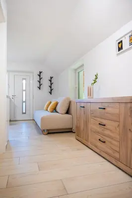 a living room with a couch and a dresser at Na-Ture Apartments in Zgornje Gorje