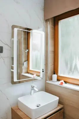 a bathroom with a sink and a mirror at Apartmaji URŠIČ in Kobarid